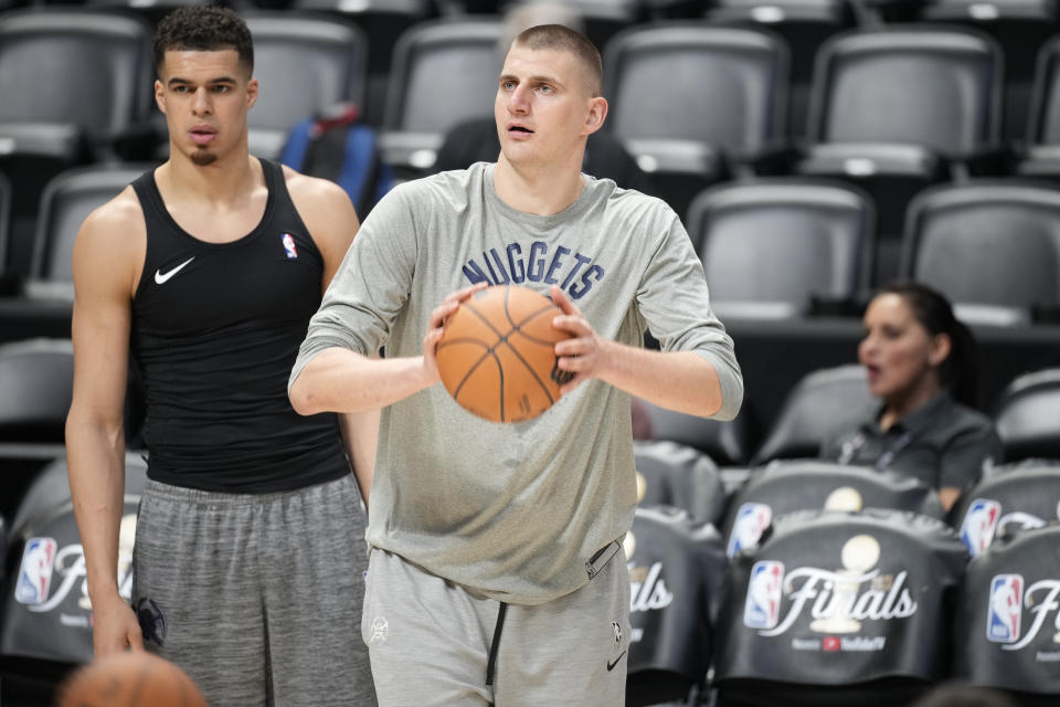 Denver Nuggets center Nikola Jokic, front right, shoots as forward Michael Porter Jr., left, looks on during practice for Game 2 of the NBA Finals, Saturday, June 3, 2023, in Denver. (AP Photo/David Zalubowski)