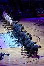 The Miami Heat team kneels during the playing of the National Anthem before an NBA basketball game against the Boston Celtics, Wednesday, Jan. 6, 2021, in Miami. (AP Photo/Marta Lavandier)