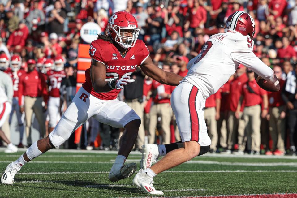 Oct 22, 2022; Piscataway, New Jersey, USA; Rutgers Scarlet Knights defensive lineman Wesley Bailey (23) rushes Indiana Hoosiers quarterback Connor Bazelak (9) resulting in an interception during the second half at SHI Stadium. Mandatory Credit: Vincent Carchietta-USA TODAY Sports