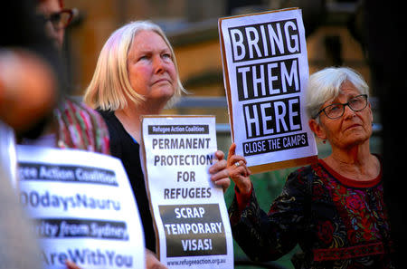 Refugee advocates hold placards and banners during a protest in central Sydney, Australia, October 5, 2016 calling for the closure of the Australian detention centres in Nauru and Manus Island. REUTERS/David Gray