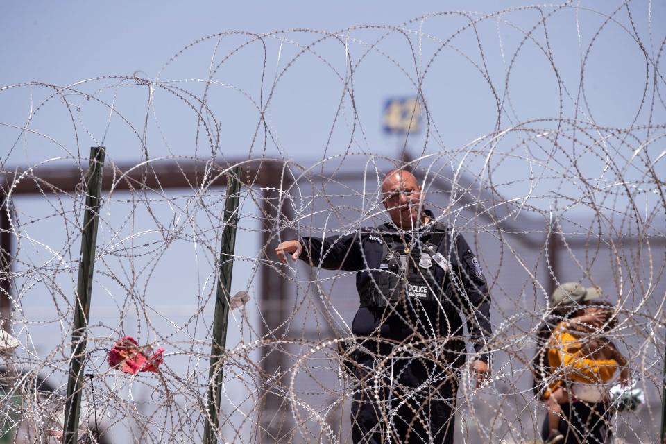 A Customs and Border Protection officer tells a migrant he can no longer enter U.S. territory at gate 42 at the border wall in El Paso, Texas on Thursday, May 11, 2023 