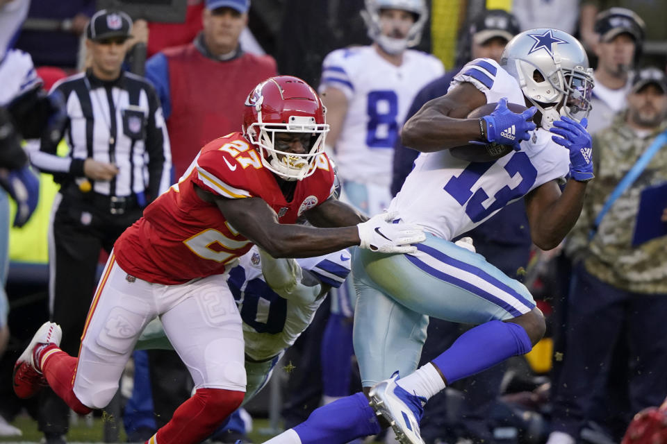 Dallas Cowboys wide receiver Michael Gallup (13) catches a pass as Kansas City Chiefs cornerback Rashad Fenton (27) defends during the first half of an NFL football game Sunday, Nov. 21, 2021, in Kansas City, Mo. (AP Photo/Ed Zurga)