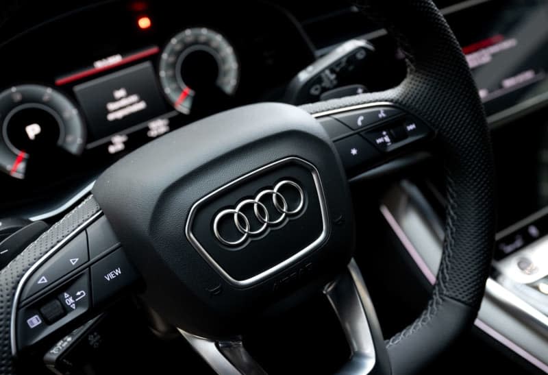 The Audi logo can be seen on the steering wheel of a car at the company headquarters before the start of the annual press conference. Sven Hoppe/dpa