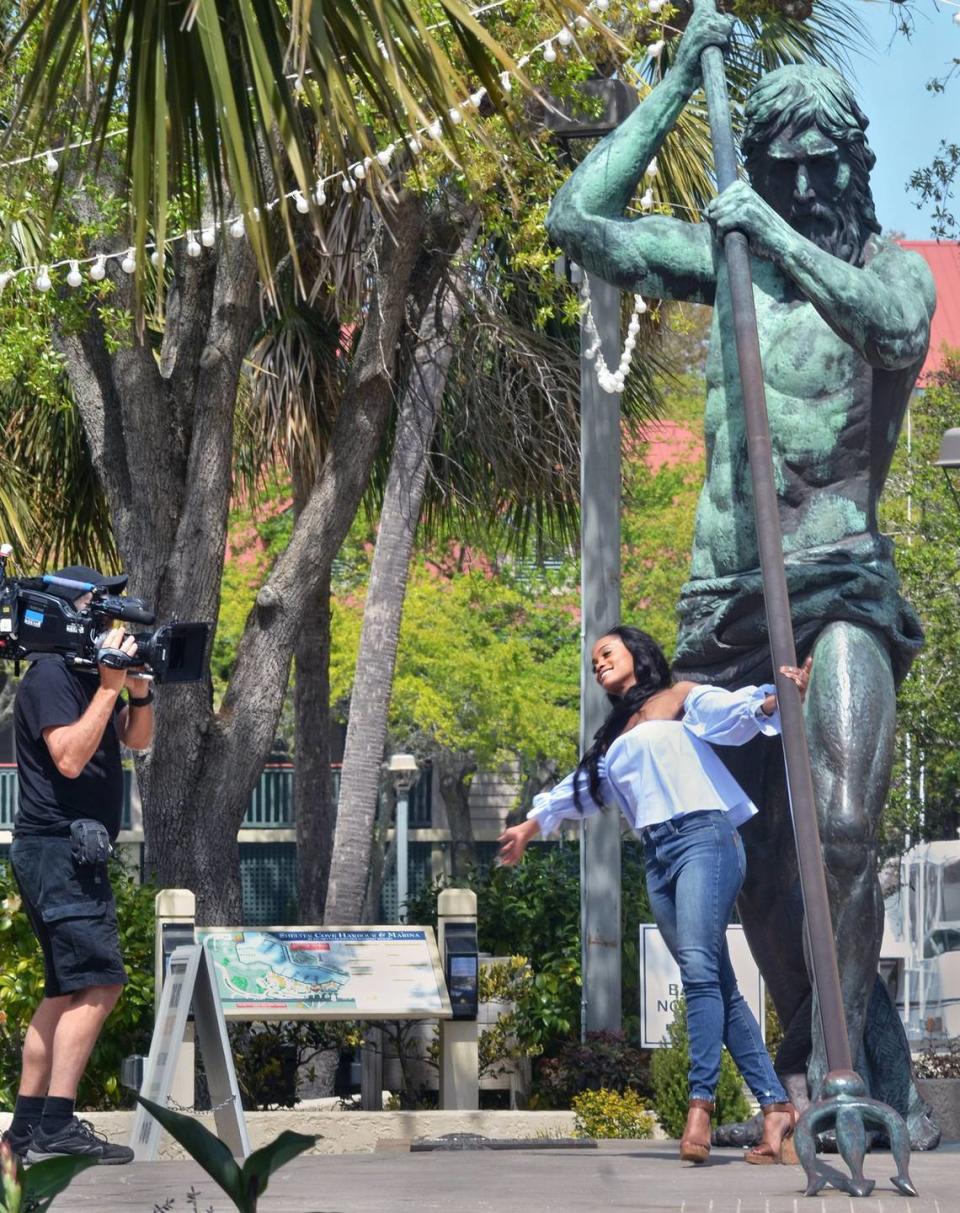 In this file photo from March, 2017, Bachelorette star Rachel Lindsay makes like a tourist and poses with the Neptune statue at Hilton Head Island's Shelter Cove Harbour during filming for the TV series.