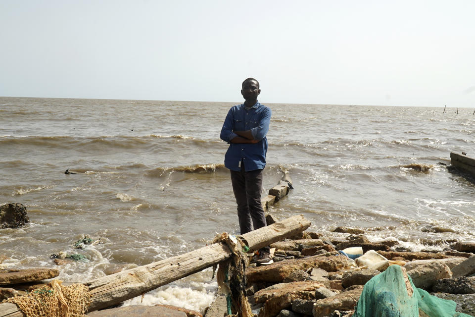 Professor Olusegun Dada, Marine Geoscientist, stands in front of a coastal area in Ayetoro, Southwest Nigeria, Thursday, April 4, 2024. Ayetoro, a coastal community more than 200 km southeast of Nigeria's business capital Lagos, has been experiencing coastal erosion for many years. But the changes have recently rapidly worsened with the community slumping into the Atlantic Ocean, leading to repeated displacements of households and businesses. (AP Photo/Dan Ikpoyi)