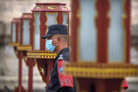 A security officer wearing a face mask to protect against the coronavirus stands guard at the Temple of Heaven in Beijing, Saturday, July 18, 2020. Authorities in a city in far western China have reduced subways, buses and taxis and closed off some residential communities amid a new coronavirus outbreak, according to Chinese media reports. They also placed restrictions on people leaving the city, including a suspension of subway service to the airport. (AP Photo/Mark Schiefelbein)