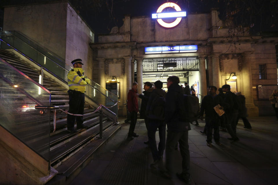 A police officer outside Embankment tube station in central London stops pedestrians from using the Hungerford Bridge, as a suspected unexploded  World War II bomb has been found in the River Thames, forcing the closure of Waterloo and Westminster bridges Thursday Jan. 19, 2017. The device was found in the river by Victoria Embankment. (Jonathan Brady/PA via AP)