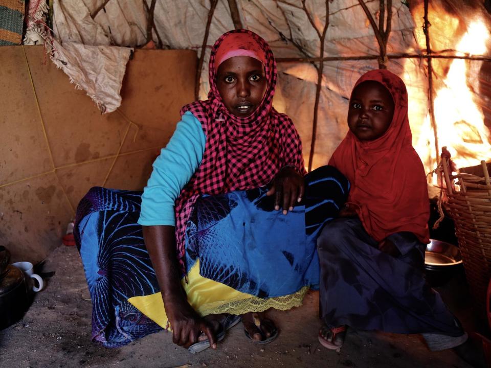 Amina Abdul Hussein sits with her three-year-old daughter Sabrin inside their makeshift tent