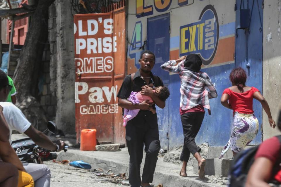 Residents flee their homes to escape clashes between armed gangs in the Carrefour-Feuilles district of Port-au-Prince, Haiti, Tuesday, Aug. 15, 2023.
