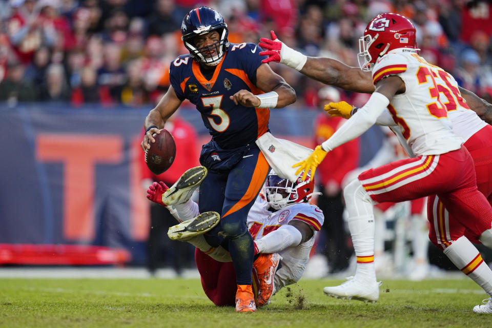 Denver Broncos quarterback Russell Wilson is sacked by Kansas City Chiefs linebacker Darius Harris, bottom, during the second half of an NFL football game Sunday, Dec. 11, 2022, in Denver. (AP Photo/Jack Dempsey)