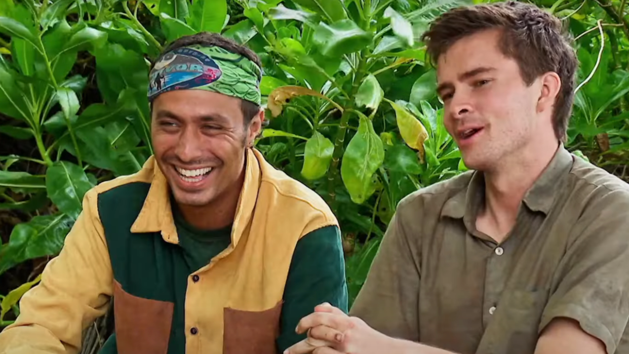  Ben And Charlie laugh while trying to name songs by their favorite artists on Survivor. 