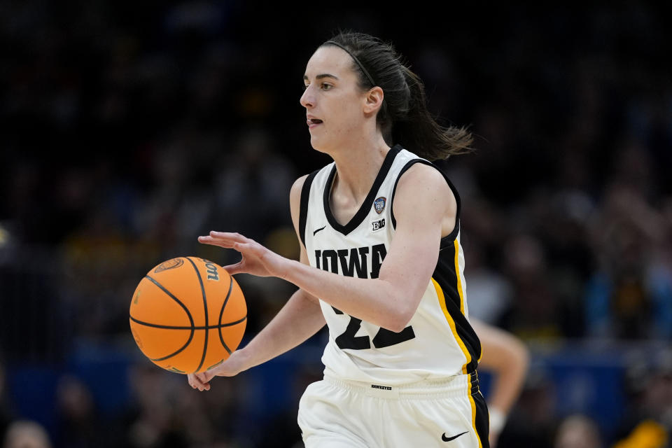 Iowa guard Caitlin Clark drives up court during the first half of a Final Four college basketball game against UConn in the women's NCAA Tournament, Friday, April 5, 2024, in Cleveland. (AP Photo/Carolyn Kaster)