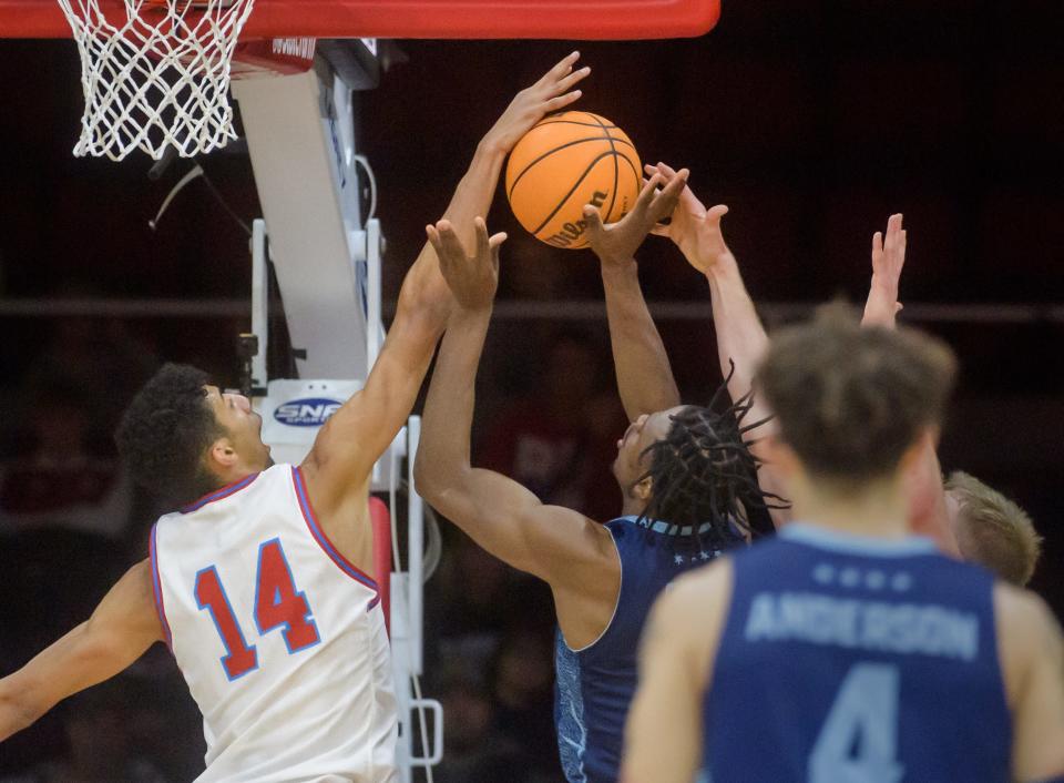 Bradley's Malevy Leons (14) blocks a shot by UIC's Toby Okani in the first half Saturday, Dec. 31, 2022 at Carver Arena. The Braves dominated the Flames 79-45.