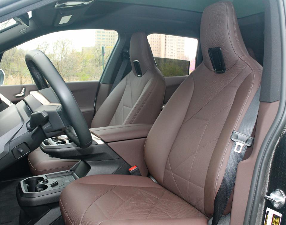 The brown-leather front seats of the 2022 BMW iX SUV.