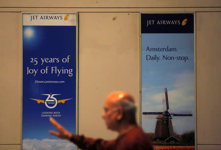 A man walks past hoardings of Jet Airways at the Chhatrapati Shivaji Maharaj International Airport in Mumbai, April 17, 2019. REUTERS/Francis Mascarenhas/Files