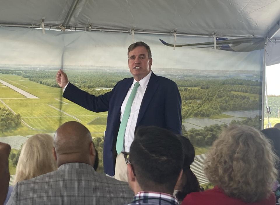 Sen. Mark Warner, D-Va., speaks during the groundbreaking ceremony for a solar power project, Tuesday, Aug. 22, 2023, at Dulles International Airport in Dulles, Va. Officials say the 150-megawatt project will be the largest renewable energy project ever built at a U.S. airport. (AP Photo/Matthew Barakat)