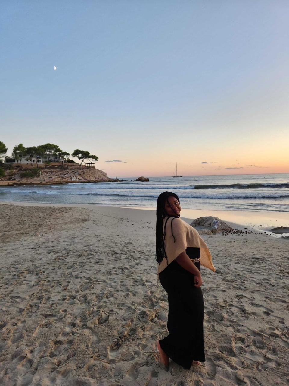 a woman standing on a beach