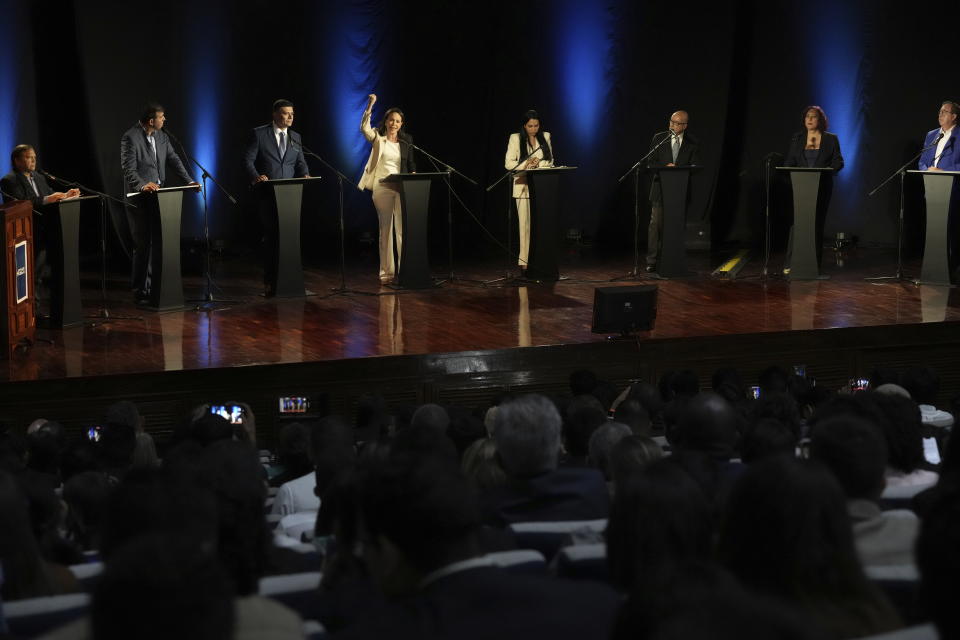 Maria Corina Machado holds up her arm as she speaks during a debate with other opposition presidential hopefuls, at the Catholic University Andres Bello UCAB in Caracas, Venezuela, Wednesday, July 12, 2023. The opposition will hold primaries on Oct 22 to choose one candidate to face President Nicolas Maduro in 2024 elections. From left are Andres Velasquez, Carlos Prosperi, Freddy Superlano, Maria Corina Machado, Delsa Solorzano, Andres Caleca, Tamara Adrian and Cesar Perez Vivas. (AP Photo/Ariana Cubillos)