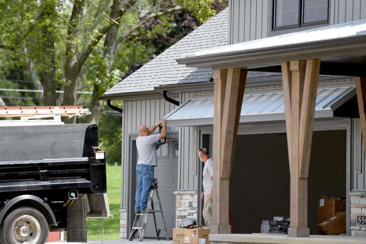 A contractor works on a Vega Construction home in The Woodlands development in Hartville where the Building Industry Association of Stark & East Central Ohio will host the Parade of Homes. The event takes place Sept. 16-24.