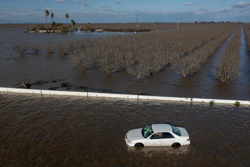 A car is stranded in floodwater as a series of atmospheric river storms melt record amounts of snow in the Sierra Nevada on March 24, 2023 near Corcoran, California. / Credit: David McNew / Getty Images