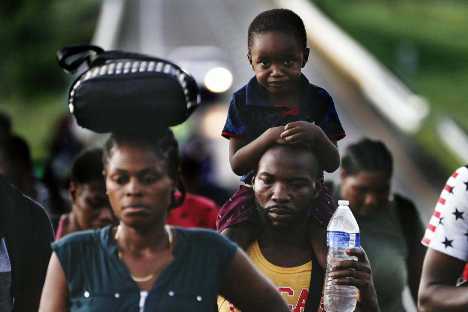 Haitian migrants walk along the highway in Huixtla, Chiapas state, Mexico, early Thursday, Sept. 2, 2021, in their journey north toward the U.S. (AP Photo/Marco Ugarte)