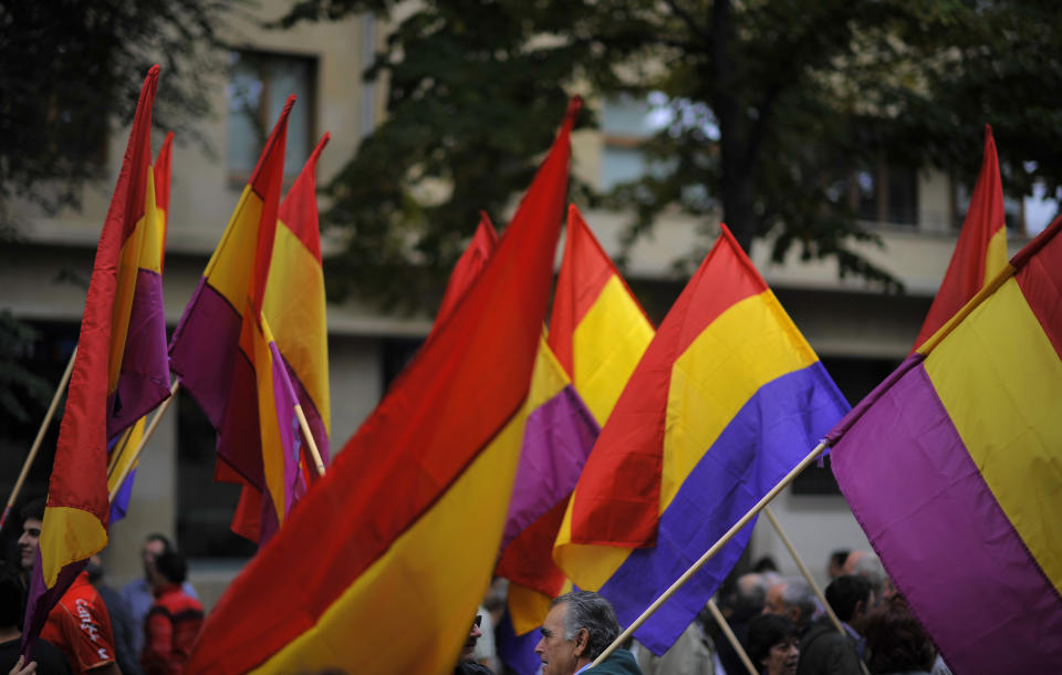 People hold up Spanish Republican flags during a protest against the Spanish Government's cutback plans, in Pamplona, northern Spain, Sunday, Oct. 7, 2012. Thousands of people called by 150 organizations are marching in 56 Spanish cities to protest punishing austerity cuts they say will only increase unemployment and job insecurity. (AP Photo/Alvaro Barrientos)