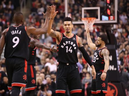 Jan 19, 2019; Toronto, Ontario, CAN; Toronto Raptors forward Danny Green (14) is congratulated by forward Serge Ibaka (9) after scoring a three pointer in the third quarter against the Memphis Grizzlies at Scotiabank Arena. The Raptors beat the Grizzlies 119-90. Mandatory Credit: Tom Szczerbowski-USA TODAY Sports