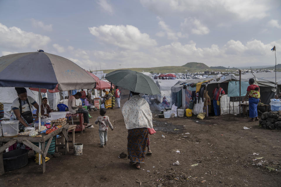 People displaced by the ongoing fighting between Congolese forces and M23 rebels gather in a camp on the outskirts of Goma, Democratic Republic of Congo, Wednesday, March 13, 2024, as OCHA (United Nations Office for the Coordination of Humanitarian Affairs) head and representative Ramesh Rajasingham, carries out a working visit to the region. (AP Photo/Moses Sawasawa)