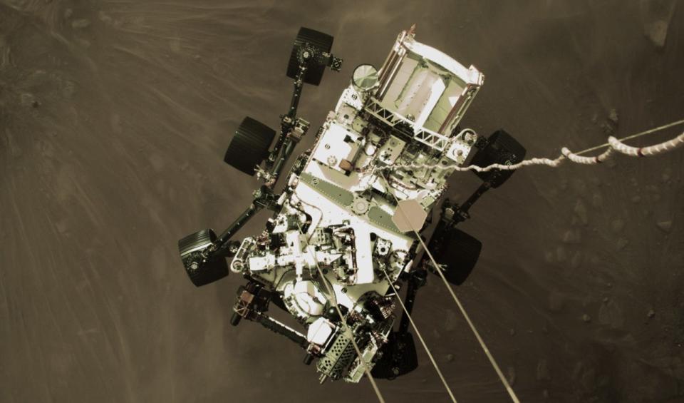 NASA's Perseverance rover is lowered onto the surface of Mars in a harrowing landing.