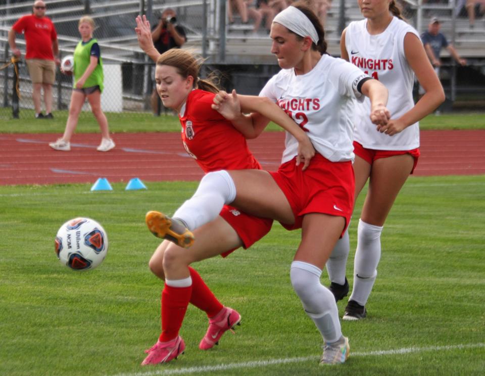 Chatham Glenwood senior Ella Gorrie, left, fights for the ball against Troy Triad in the Class 2A supersectional at the Glenwood Athletic Complex on Tuesday, May 31, 2022.