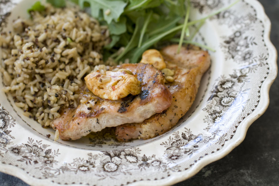 This Sept. 30, 2013 photo shows pork chops with chipotle pumpkin seed butter in Concord, N.H. (AP Photo/Matthew Mead)