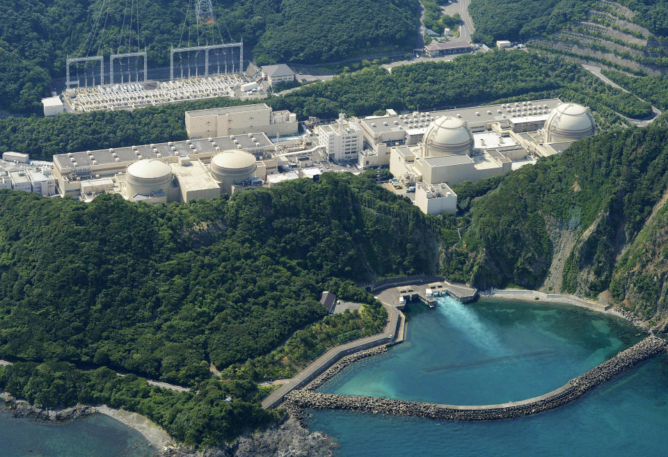 This aerial photo shows Kansai Electric Power Co.'s unit buildings, from left, No. 1, No. 2, No. 3, and No. 4 of the Ohi nuclear power plant in Ohi, Fukui prefecture, western Japan, Friday, Nov. 2, 2012. Japanese nuclear regulators inspected ground structures Friday at the country's only operating nuclear plant to examine if an existing fault line is active. The inspection determines whether the Ohi plant should close. Its No. 3 and No. 4 reactors went back online in July, becoming Japan's only operating reactors after all 50 Japanese reactors went offline for inspection following the March 11, 2011, crisis at Fukushima Dai-ichi. (AP Photo/Kyodo News) JAPAN OUT, MANDATORY CREDIT, NO LICENSING IN CHINA, FRANCE, HONG KONG, JAPAN AND SOUTH KOREA