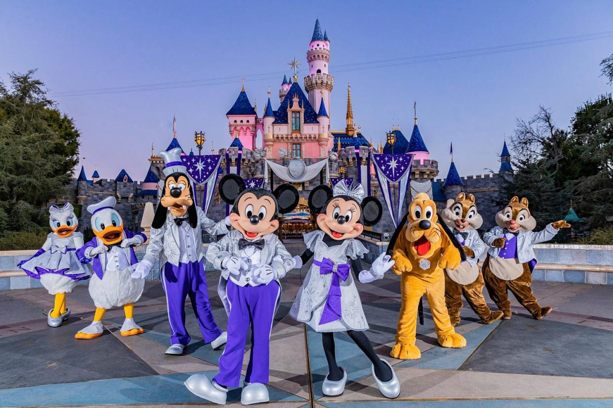 Mickey Mouse, Minnie Mouse and their pals pose in front of Sleeping Beauty Castle in their shimmering new looks at the Disneyland Resort in Anaheim Calif, that begins commemorating The Walt Disney Company's 100th anniversary on Jan. 27, 2023