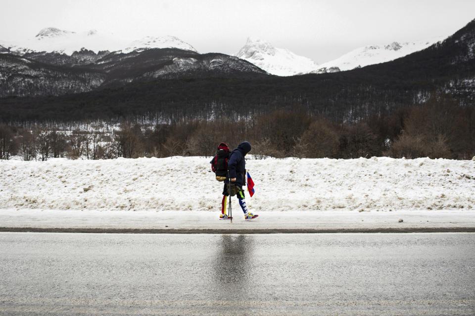 Venezuelan Yeslie Aranda, 57, walks on Route 3, as part of his promise to travel throughout South America with one leg and a prosthesis, between Tolhuin and Ushuaia, Argentina, Saturday, Aug. 17, 2019. Aranda left his hometown of San Cristobal in the southeastern state of Táchira last year with a backpack, $30 in his pocket and an aluminum prosthesis that enabled him to negotiate the continent’s rugged roads. (AP Photo/Luján Agusti)