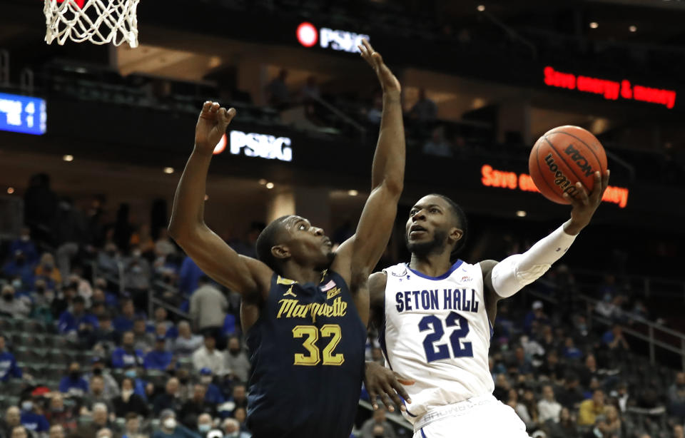 Seton Hall guard Myles Cale (22) drives to the basket against Marquette guard Darryl Morsell (32) during the second half of an NCAA college basketball game in Newark, N.J. Marquette won 73-63. Wednesday, Jan. 26, 2022. (AP Photo/Noah K. Murray)