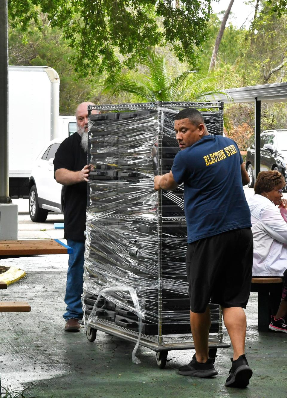 Brevard County Supervisor of Elections Office staff wheel in voting equipment at the Tony Rosa Palm Bay Community Center, one of 10 sites in Brevard where 10 days of early voting begins Saturday for the Republican presidential primary.