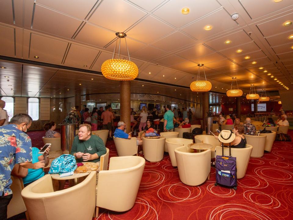 A group of lounge seats. People are scattered around the seats.