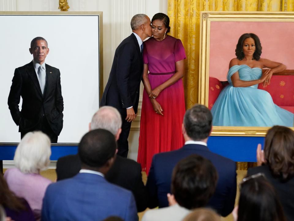 Former President Barack Obama kisses his wife former first lady Michelle Obama after they unveiled their official White House portraits during a ceremony for the unveiling in the East Room of the White House, Wednesday, Sept. 7, 2022, in Washington.