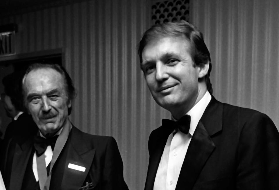 Two men in formal wear stand next to each other