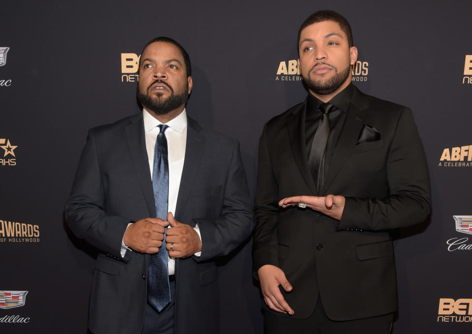 Ice Cube and son O'Shea Jackson Jr. wearing suits.