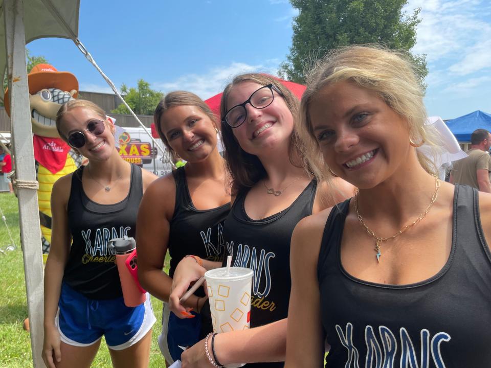 Karns High School cheerleaders cheer their favorite contestant, Caroline Matthews, 17, at the rib eating contest at the Karns Community Fair held at Karns High School Saturday, July 16, 2022. From left: Kinsley Gardner, 17, Evelyn McNeeley, 16, Addy Hutchison, 15, Hannah Little, 16.