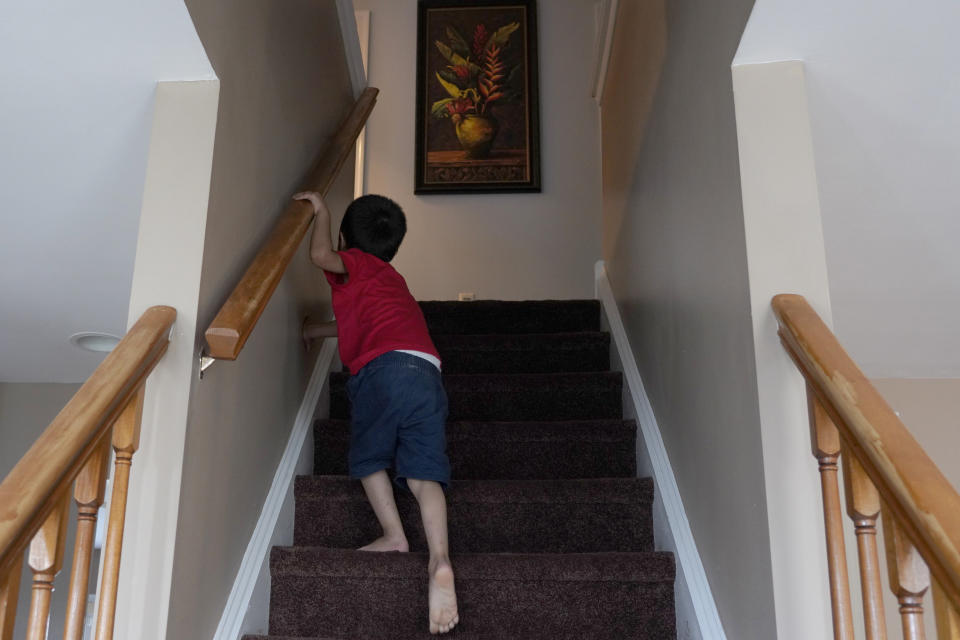 An Afghan refugee who came with his family to the United States climbs upstairs at a house in Bensalem, Pa., Thursday, Aug. 26, 2021. The family agreed to be photographed on the condition that they not be identified because of security concerns. (AP Photo/Michael Perez)