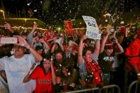 Fans celebrate after the San Francisco Giants defeated the Kansas City Royals to win the World Series during a television viewing event at the Civic Center in San Francisco, California October 29, 2014. REUTERS/Robert Galbraith