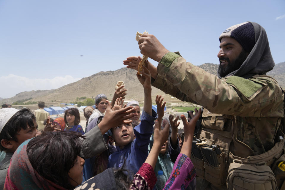 Afghans receive aid at a camp after an earthquake in Gayan district in Paktika province, Afghanistan, Sunday, June 26, 2022. A powerful earthquake struck a rugged, mountainous region of eastern Afghanistan early Wednesday, flattening stone and mud-brick homes in the country's deadliest quake in two decades, the state-run news agency reported. (AP Photo/Ebrahim Nooroozi)