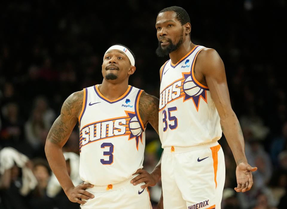 Phoenix Suns guard Bradley Beal (3) and forward Kevin Durant (35) talk during the fourth quarter against the Brooklyn Nets at Footprint Center in Phoenix on Dec. 13, 2023.