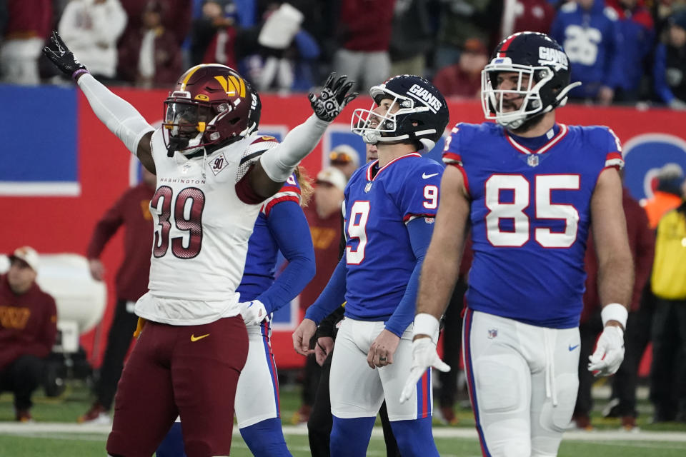 New York Giants kicker Graham Gano, center, looks after his field goal during overtime of an NFL football game against the Washington Commanders, Sunday, Dec. 4, 2022, in East Rutherford, N.J. The kick missed and the game ended in a tie. (AP Photo/John Minchillo)