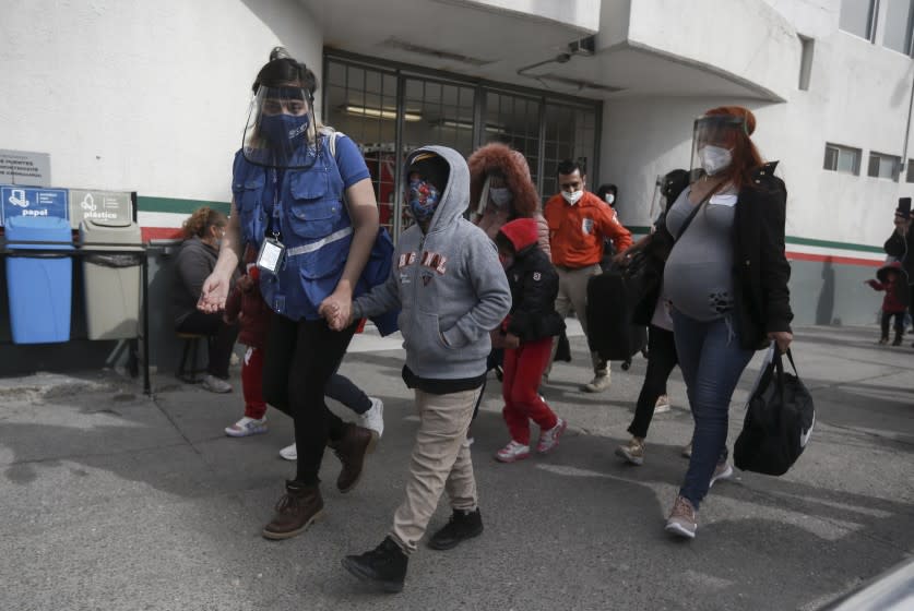 FILE - In this Friday, Feb. 26, 2021, file photo, a migrant family crosses the border into El Paso, Texas, in Ciudad Juarez, Mexico. The Biden administration hopes to relieve the strain of thousands of unaccompanied children coming to the southern border by terminating a 2018 Trump-era order that discouraged potential family sponsors from coming forward to house the children. (AP Photo/Christian Chavez, File)