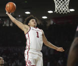 Oklahoma forward Jalen Hill goes up for a dunk during the second half of the team's NCAA college basketball game against Florida in Norman, Okla., Wednesday, Dec. 1, 2021. (AP Photo/Kyle Phillips)