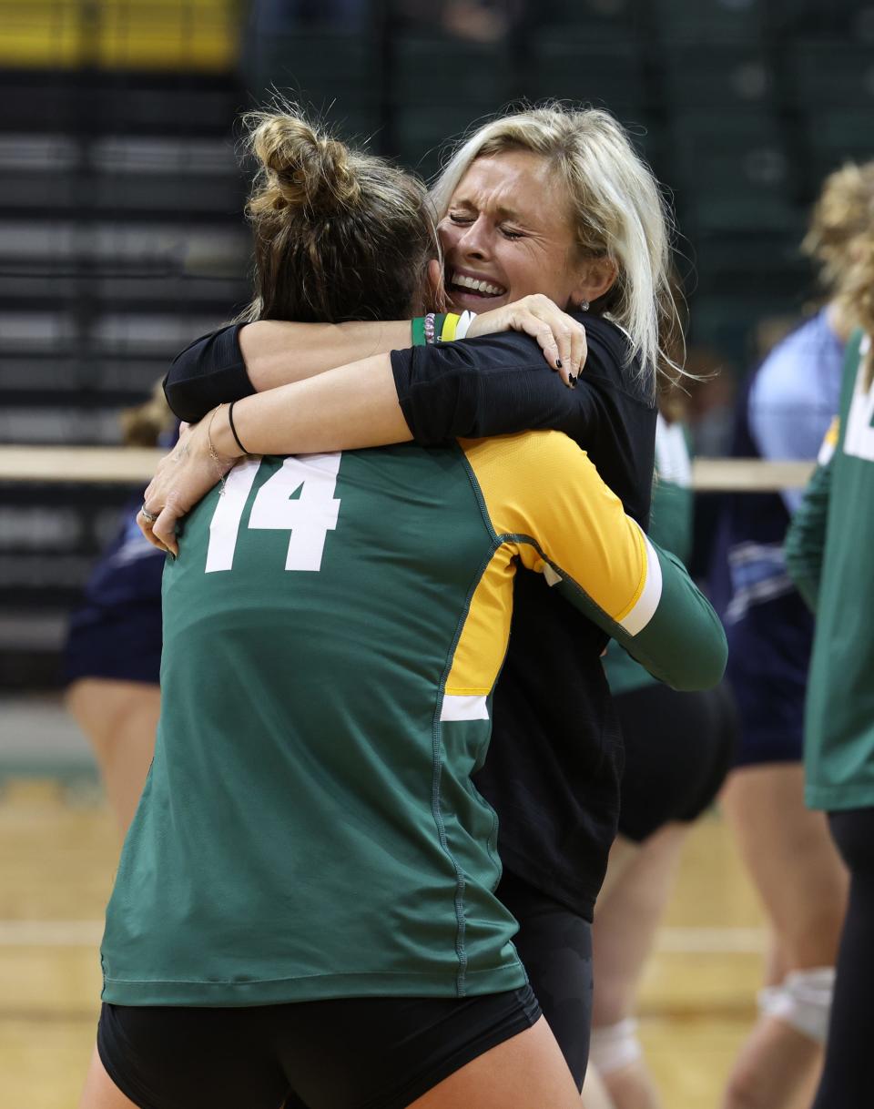 Ali Butcher (right), the Ursuline Academy head coach, hugs setter Lindsey Green, a senior, as they celebrate winning the Ohio Division I state championship Nov. 12, 2022, at Wright State University. Ursuline defeated Magnificat, 3-1, to earn the title.