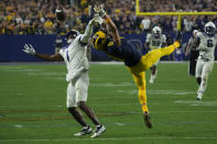 Michigan wide receiver Ronnie Bell (8) can't make the catch as TCU cornerback Tre'Vius Hodges-Tomlinson (1) defends during the second half of the Fiesta Bowl NCAA college football semifinal playoff game, Saturday, Dec. 31, 2022, in Glendale, Ariz. Hodges-Tomlinson was called for pass interference on the play. (AP Photo/Rick Scuteri)